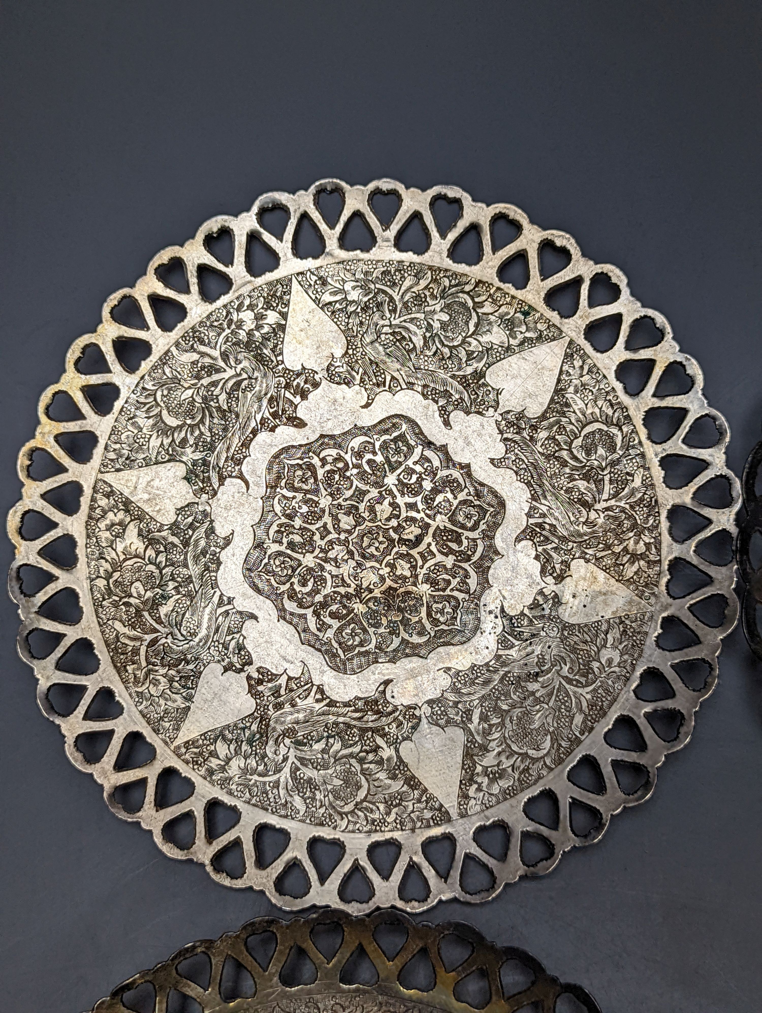 A set of six Persian white metal circular shallow dishes, with pierced borders, 16.3cm, 972 grams.